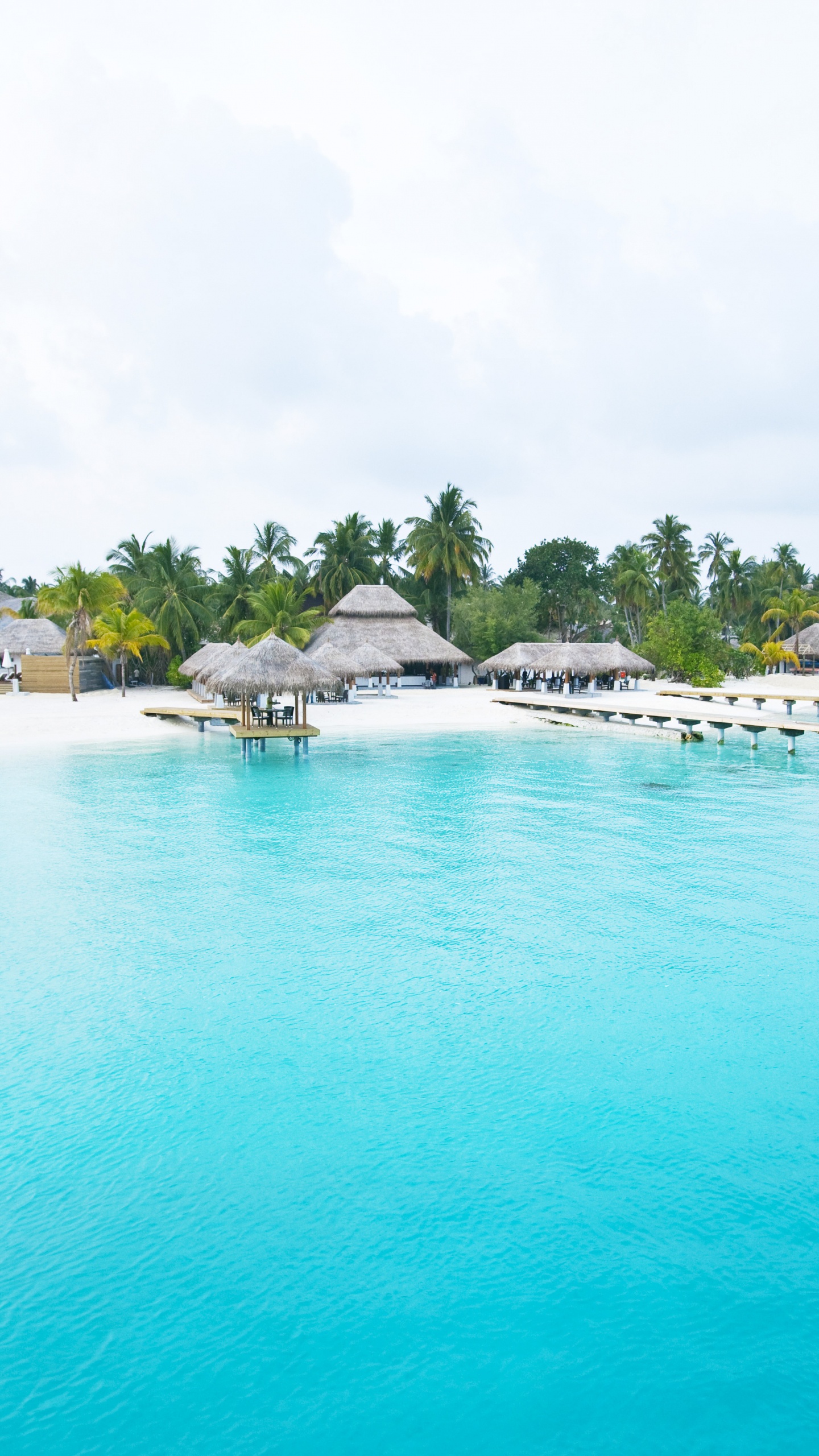 White and Brown Wooden Beach Houses Near Body of Water During Daytime. Wallpaper in 1440x2560 Resolution