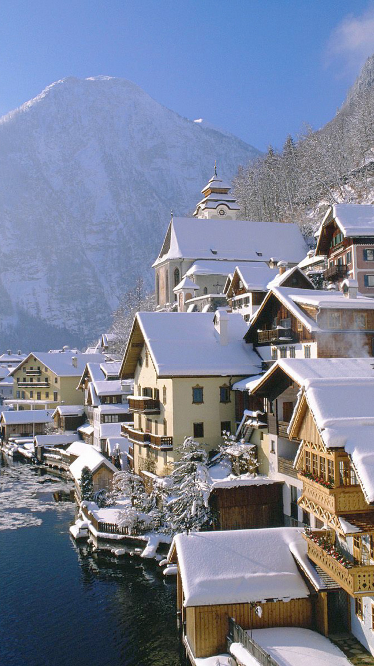 White and Brown Houses Near Body of Water During Daytime. Wallpaper in 750x1334 Resolution