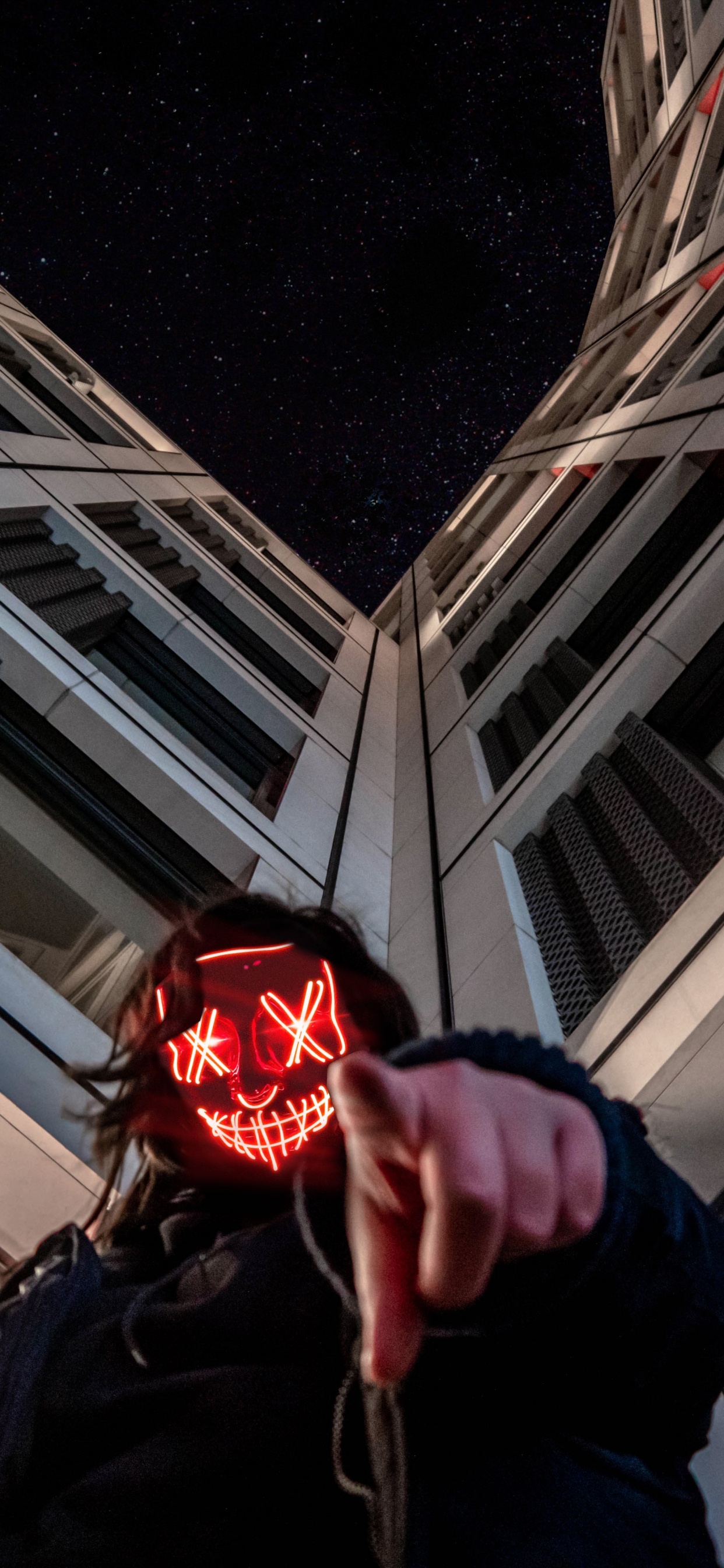 Person in Black Jacket Holding Red Ball. Wallpaper in 1242x2688 Resolution