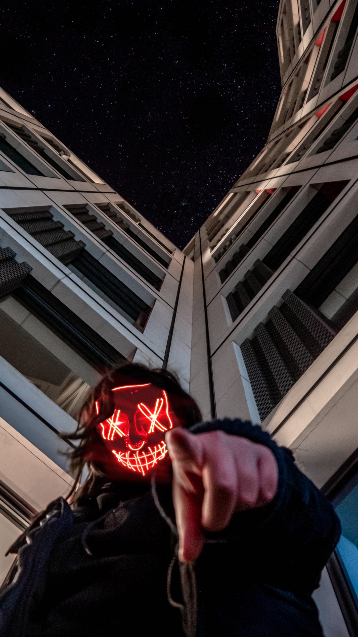 Person in Black Jacket Holding Red Ball. Wallpaper in 1440x2560 Resolution