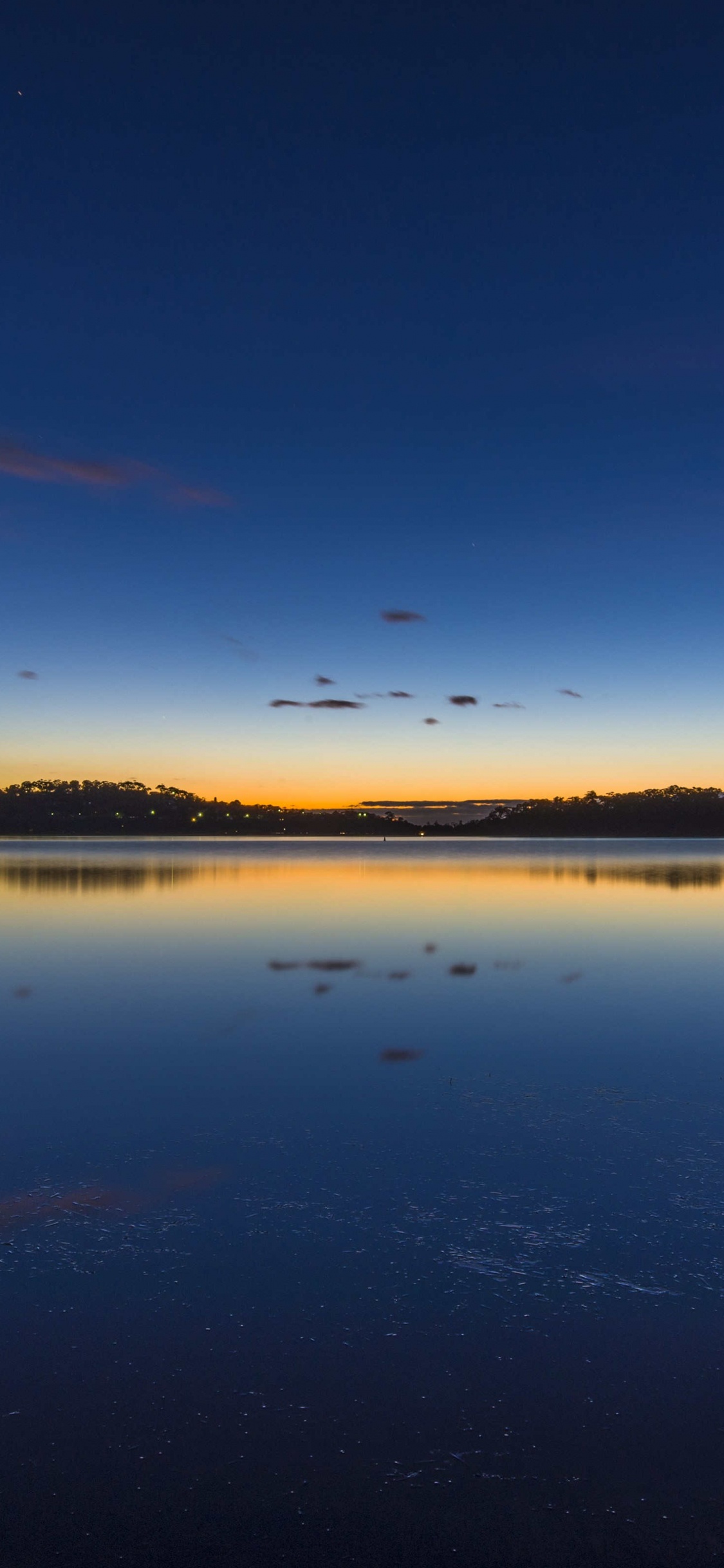 Body of Water Under Blue Sky During Daytime. Wallpaper in 1125x2436 Resolution
