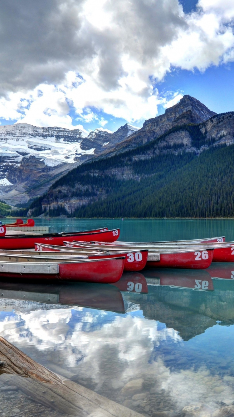 Red Boat on Lake Near Mountain Under Blue Sky During Daytime. Wallpaper in 750x1334 Resolution