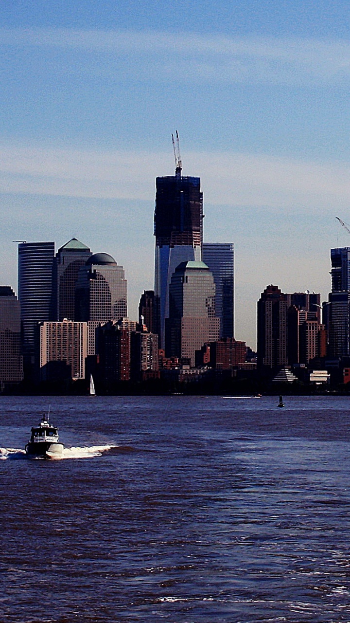 City Skyline Across Body of Water During Daytime. Wallpaper in 720x1280 Resolution