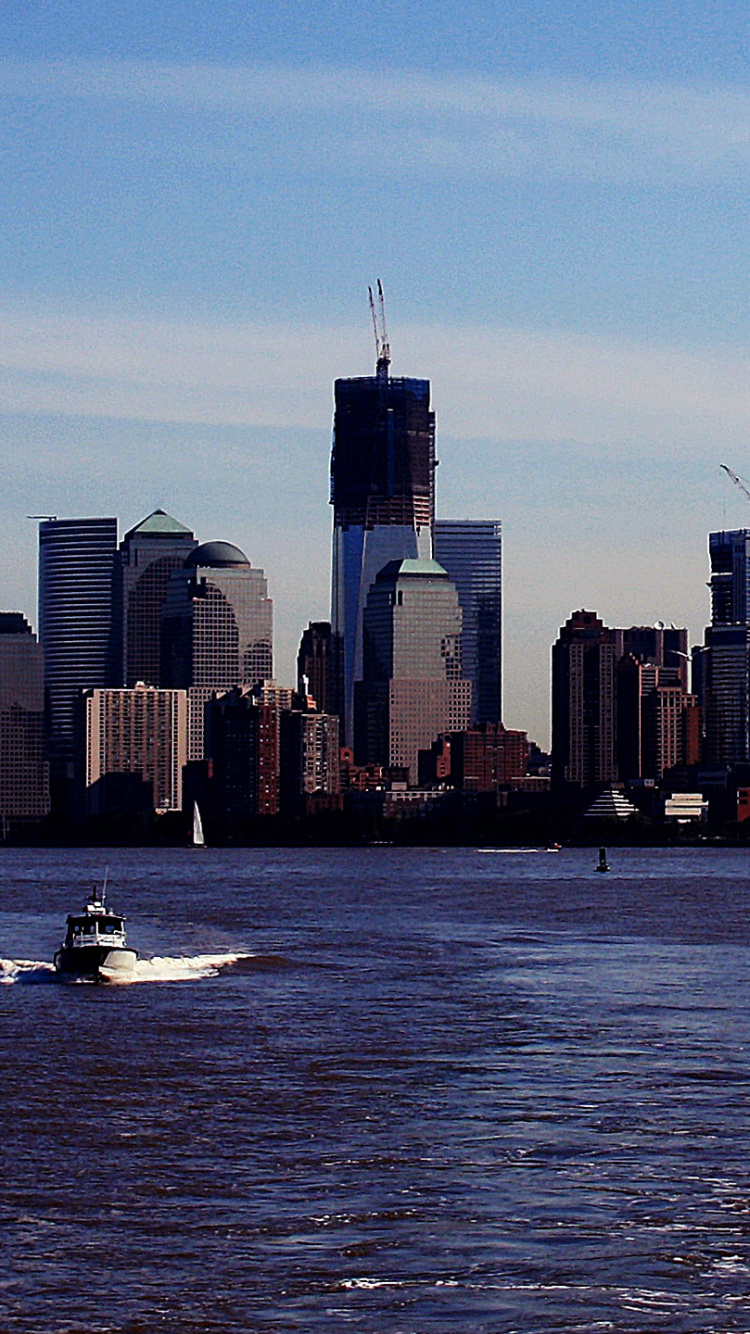 City Skyline Across Body of Water During Daytime. Wallpaper in 750x1334 Resolution