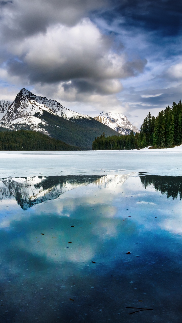 Snow Covered Mountain Near Green Pine Trees Under White Clouds and Blue Sky During Daytime. Wallpaper in 720x1280 Resolution