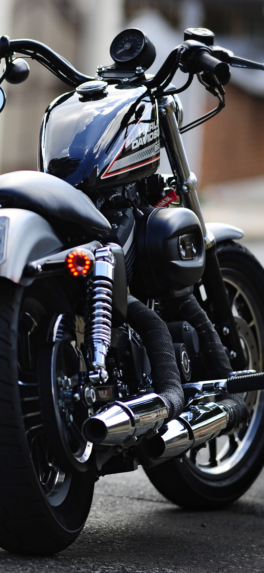 Black Cruiser Motorcycle on Road During Daytime. Wallpaper in 1125x2436 Resolution