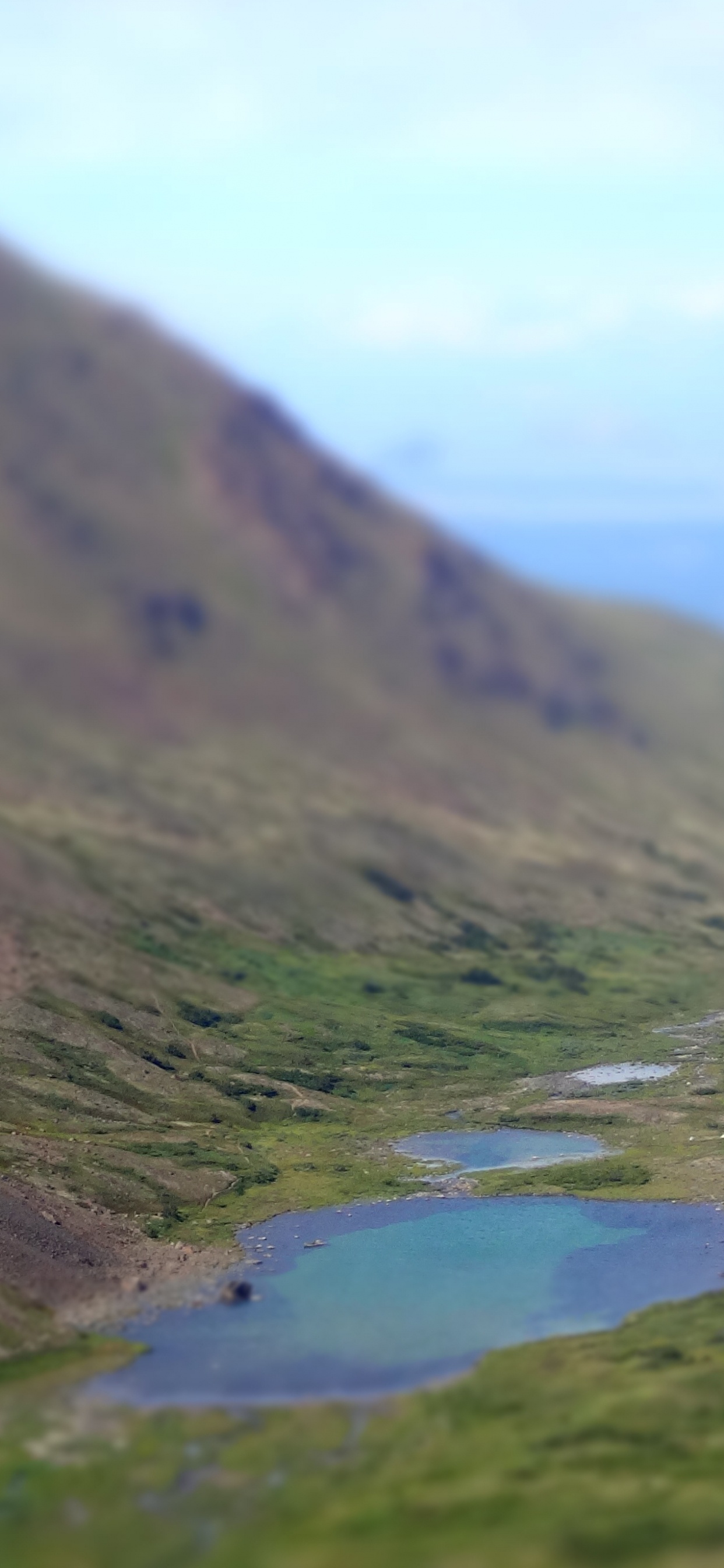 Green Mountains Near Lake Under White Clouds During Daytime. Wallpaper in 1242x2688 Resolution