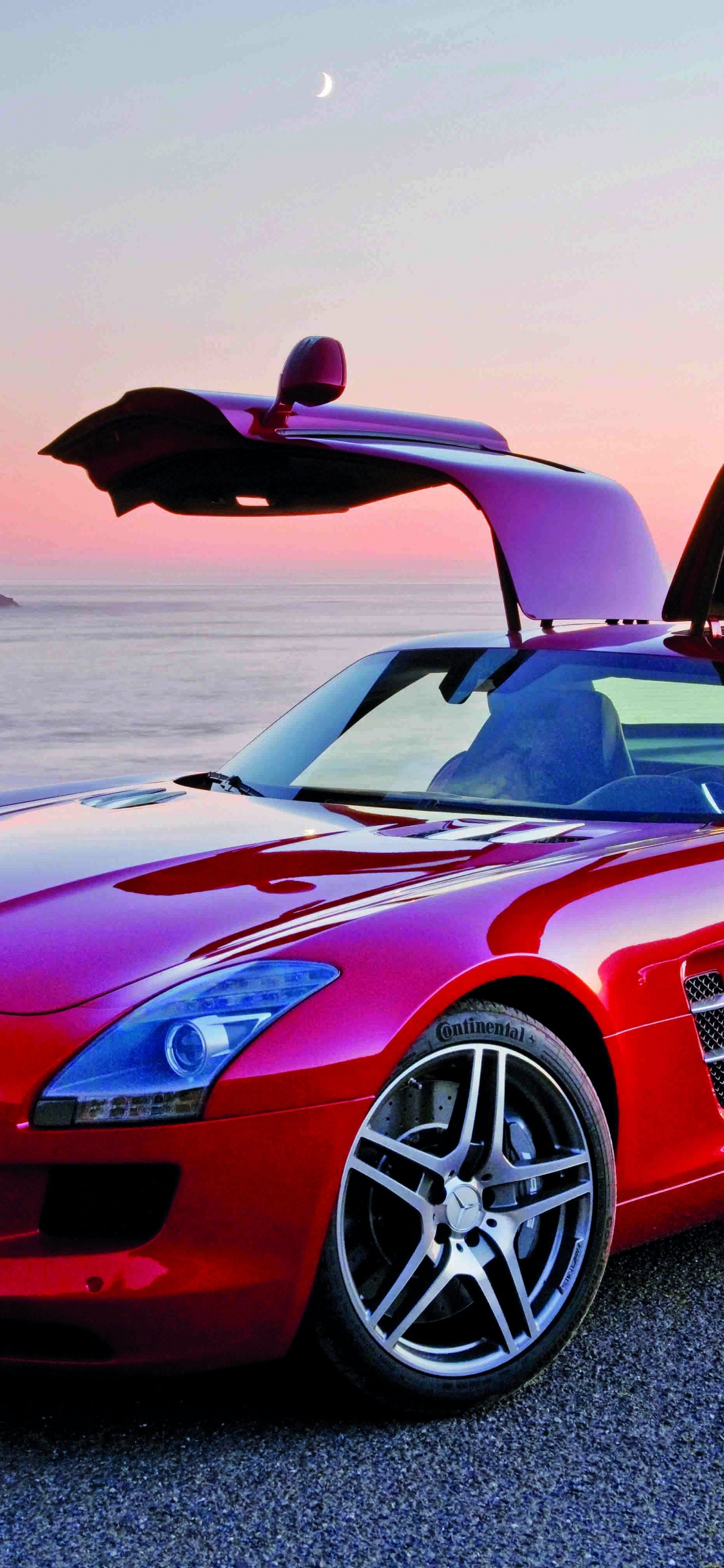 Red Ferrari 458 Italia on Gray Sand During Daytime. Wallpaper in 1125x2436 Resolution