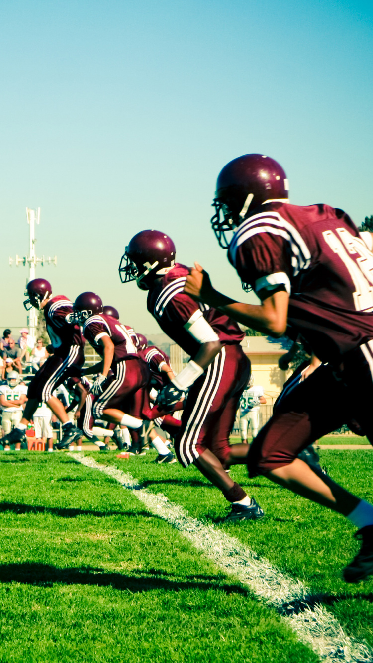 Football Players on Green Grass Field During Daytime. Wallpaper in 750x1334 Resolution