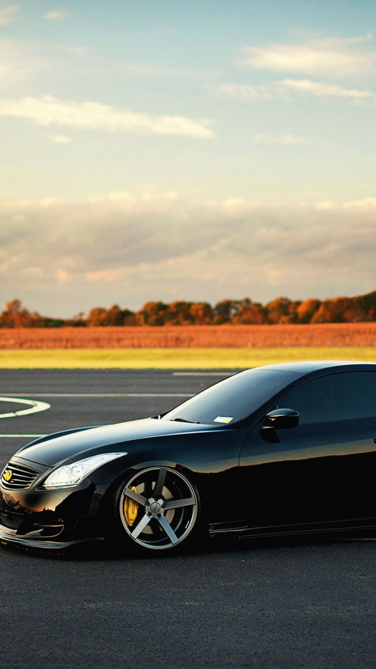 Black Coupe on Gray Asphalt Road During Daytime. Wallpaper in 750x1334 Resolution