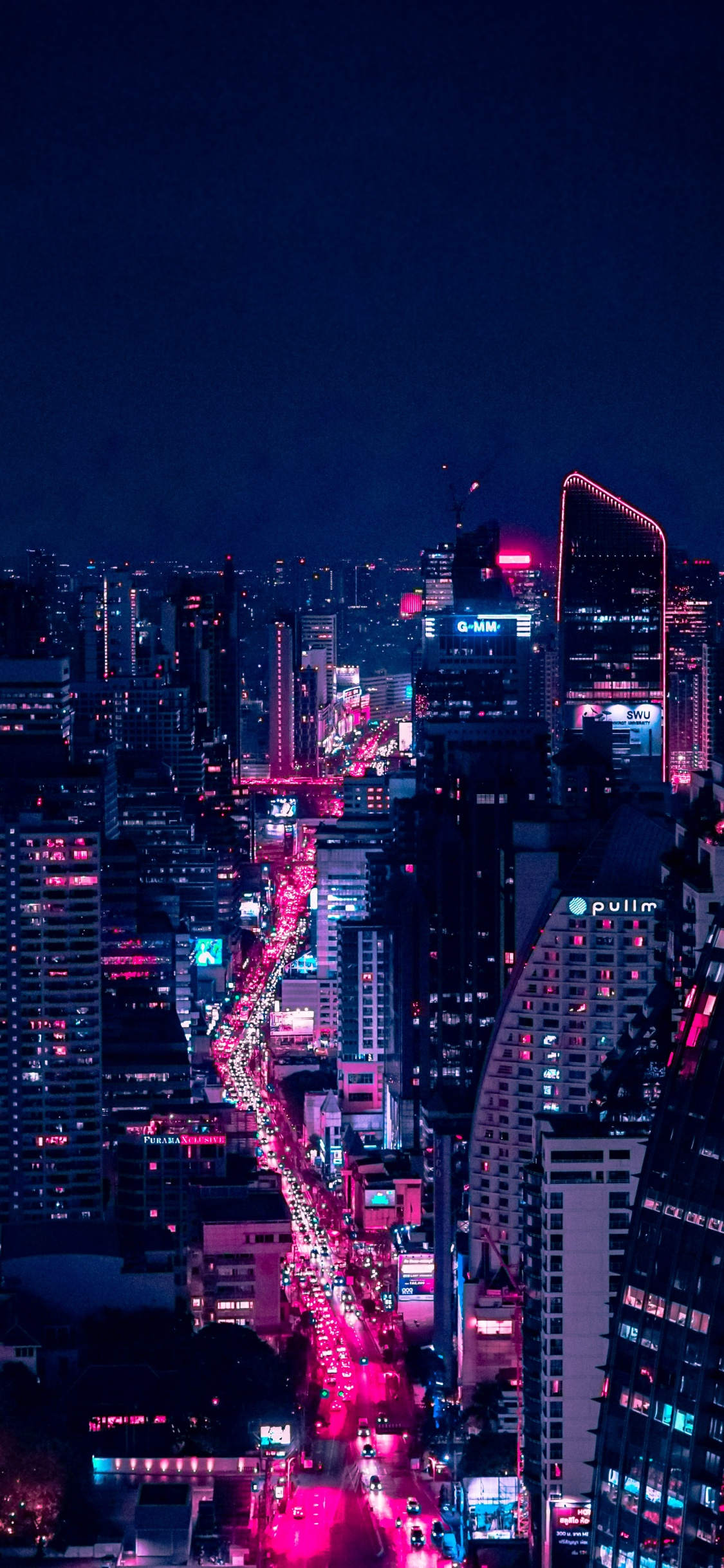Ville Avec Des Immeubles de Grande Hauteur Pendant la Nuit. Wallpaper in 1125x2436 Resolution