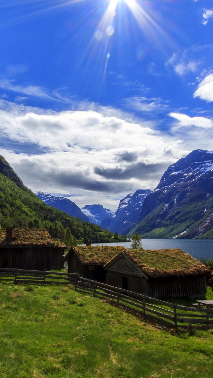 Brown Wooden House on Green Grass Field Near Mountain Under Blue Sky During Daytime. Wallpaper in 720x1280 Resolution