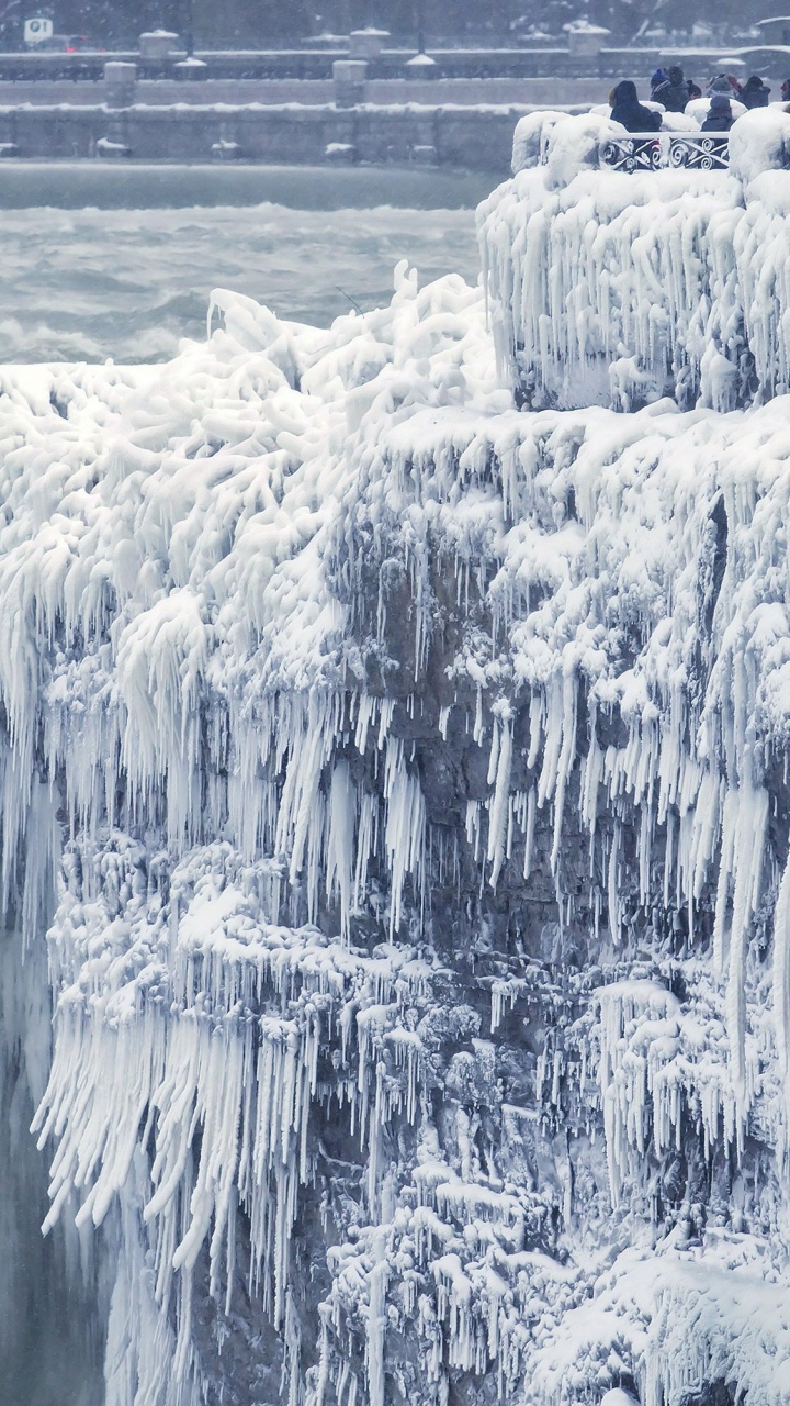 Grayscale Photo of People on Rock Formation. Wallpaper in 720x1280 Resolution