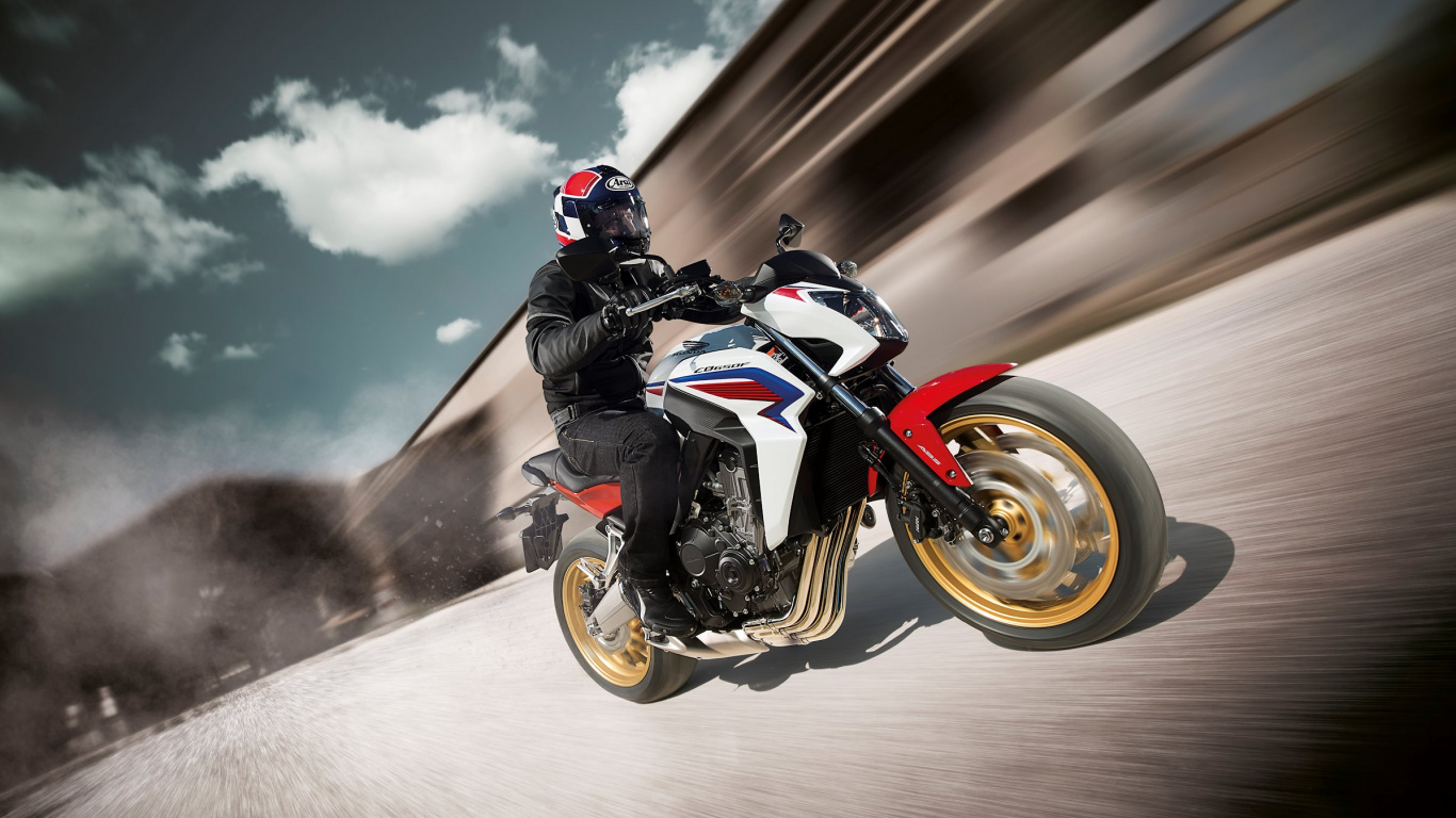 Man in Black and White Motorcycle Suit Riding Orange and Black Sports Bike. Wallpaper in 1366x768 Resolution