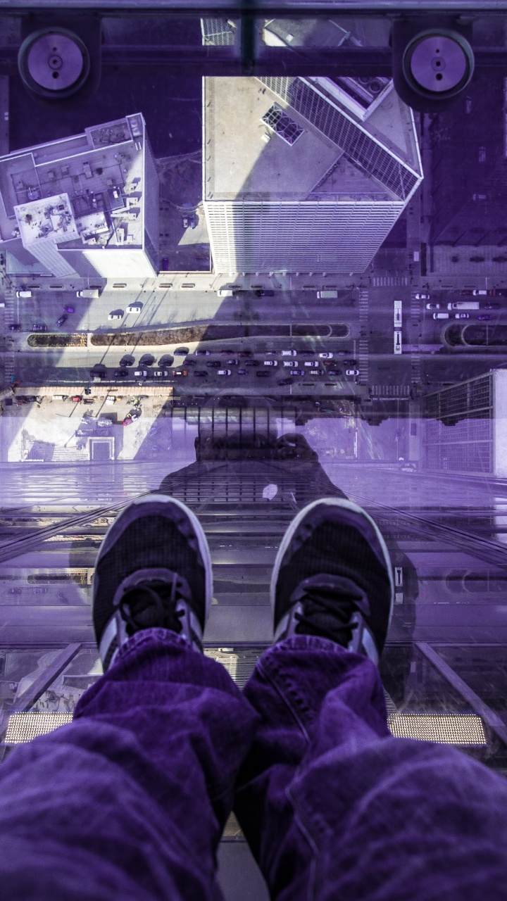Person in Red Pants and Black Shoes Sitting on The Edge of a Building. Wallpaper in 720x1280 Resolution