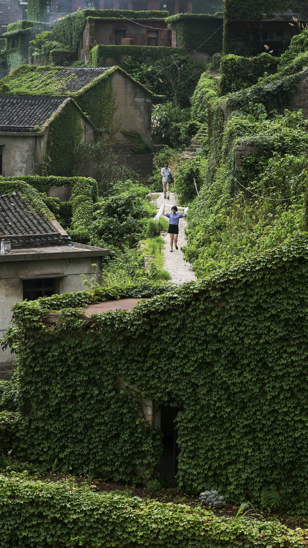 Person in White Shirt Walking on Green Grass Field During Daytime. Wallpaper in 1080x1920 Resolution