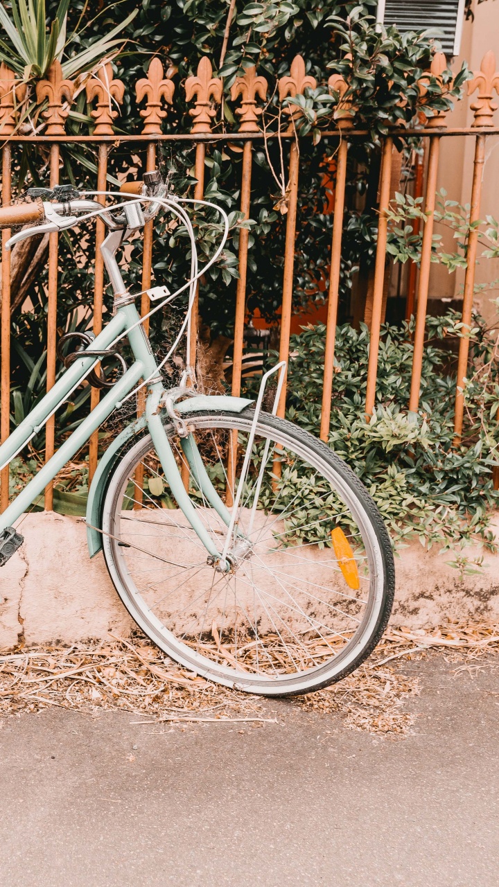 White City Bike Beside Fence. Wallpaper in 720x1280 Resolution