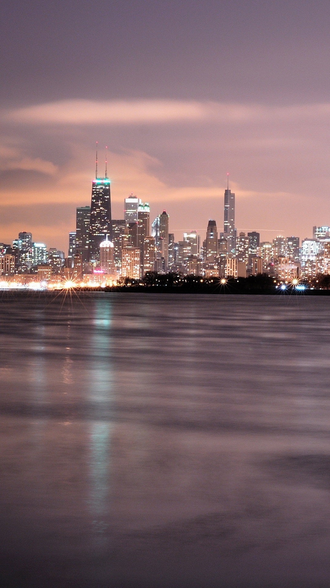 City Skyline Across Body of Water During Night Time. Wallpaper in 1080x1920 Resolution