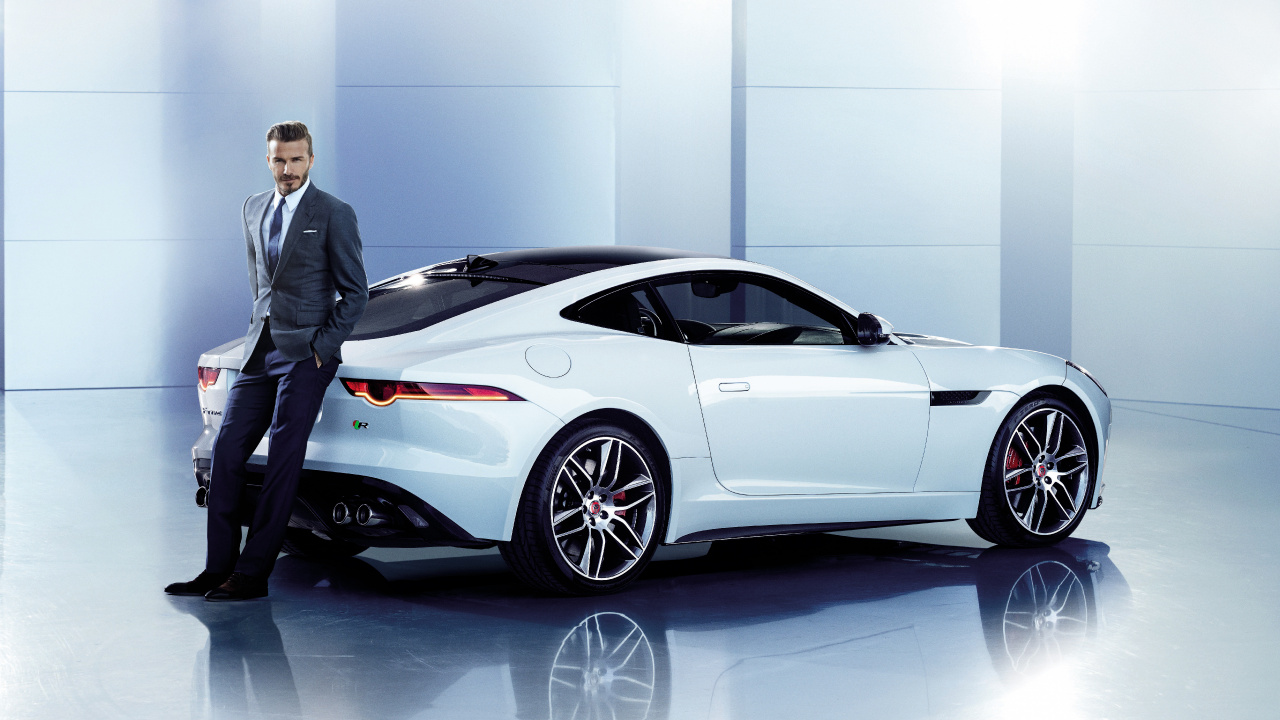 Man in Black Suit Standing Beside White Porsche 911 Coupe. Wallpaper in 1280x720 Resolution