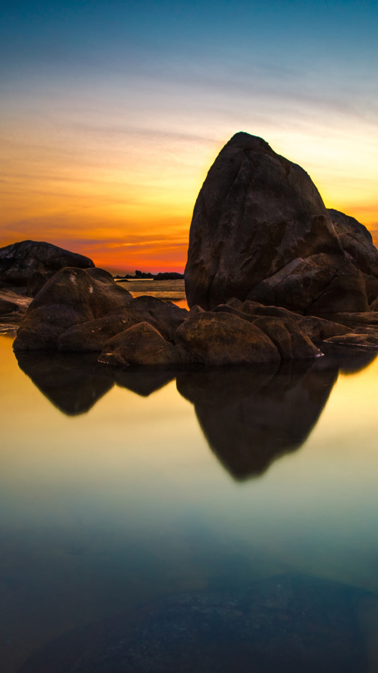 Brown Rock Formation on Body of Water During Daytime. Wallpaper in 750x1334 Resolution