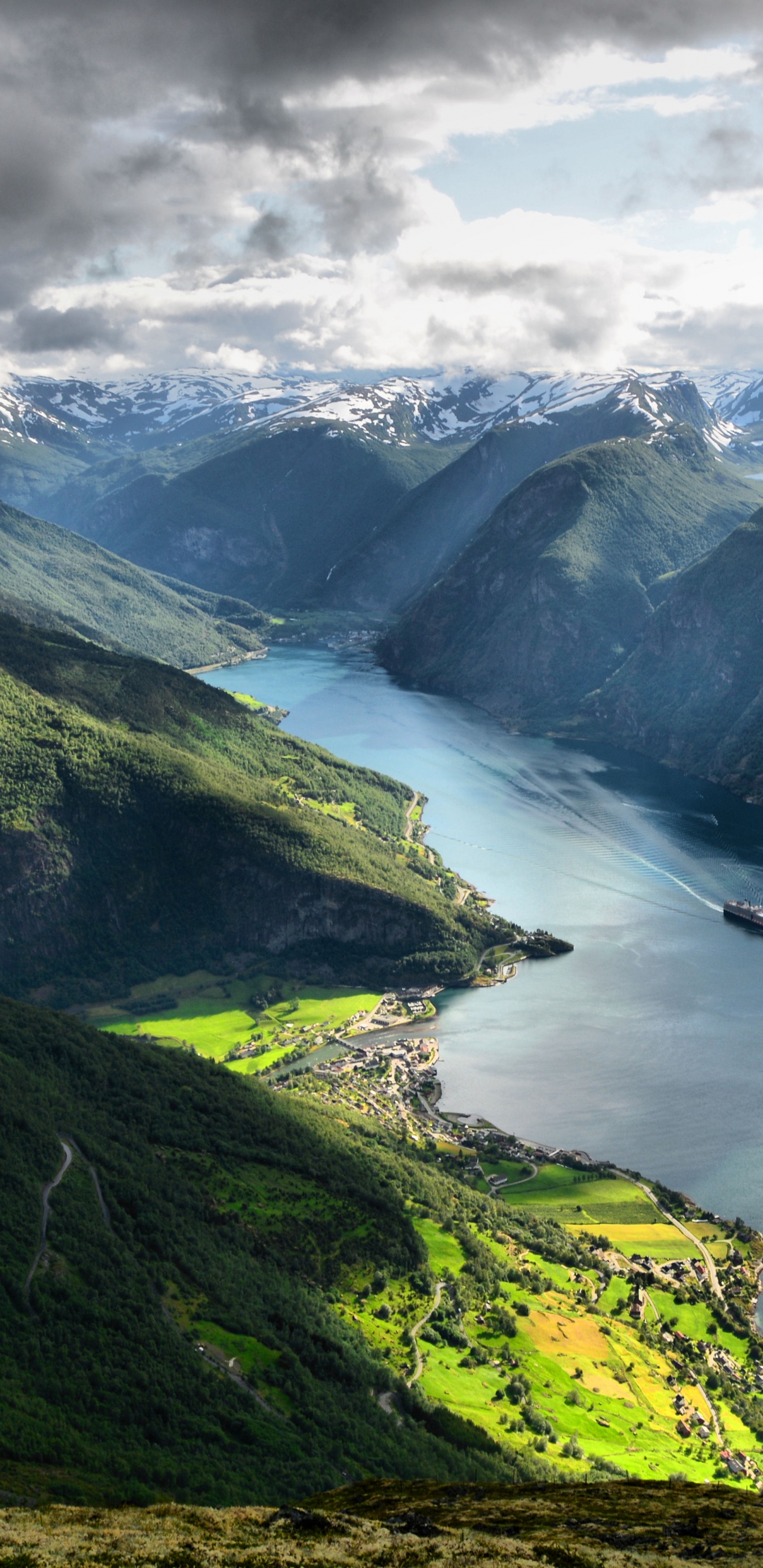 Green Mountains Near Body of Water Under White Clouds During Daytime. Wallpaper in 1440x2960 Resolution