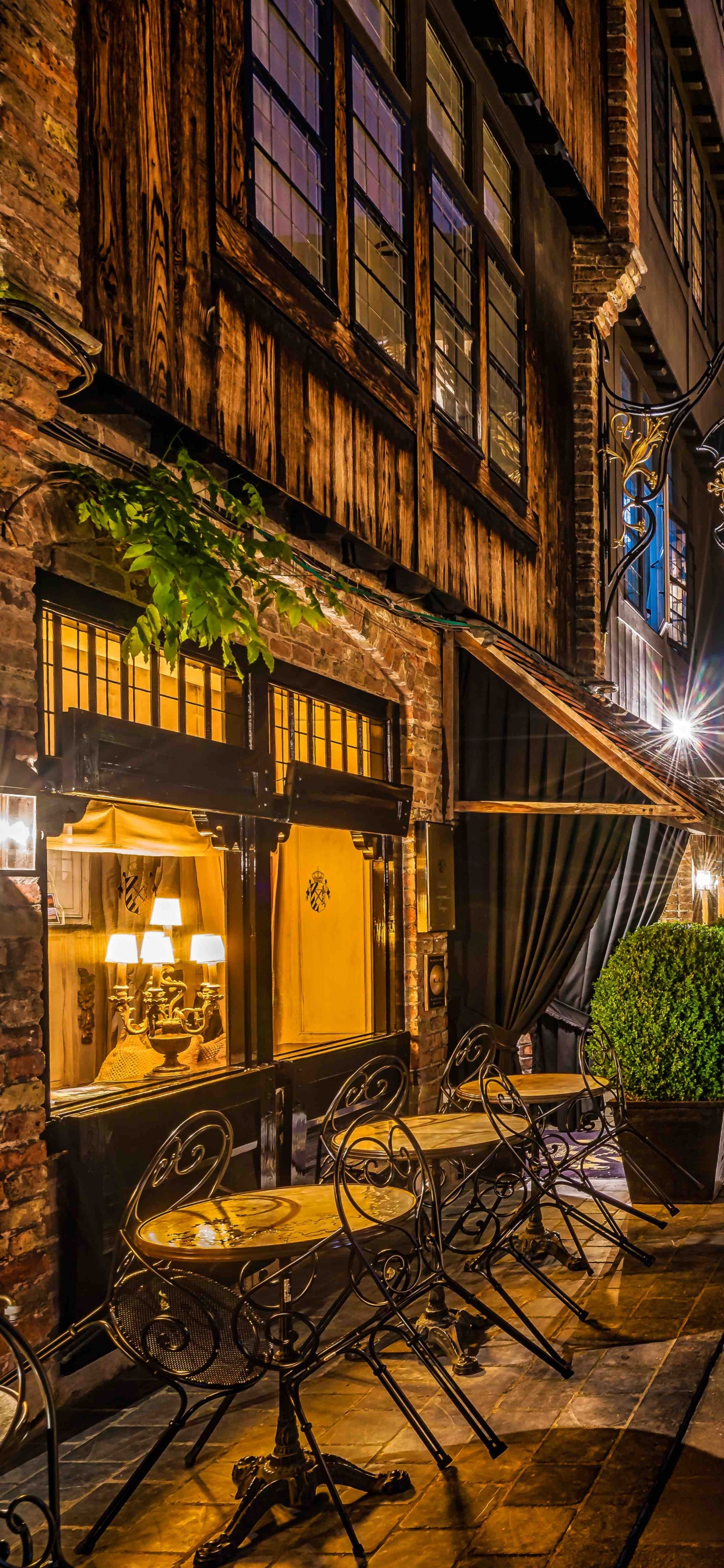 Brown Concrete Building During Nighttime. Wallpaper in 1242x2688 Resolution