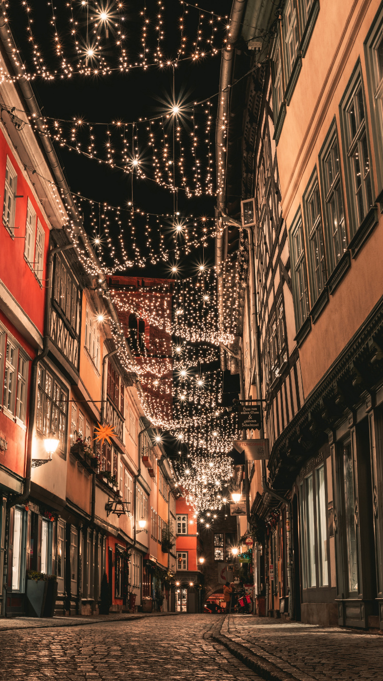 People Walking on Street Between Buildings During Daytime. Wallpaper in 750x1334 Resolution