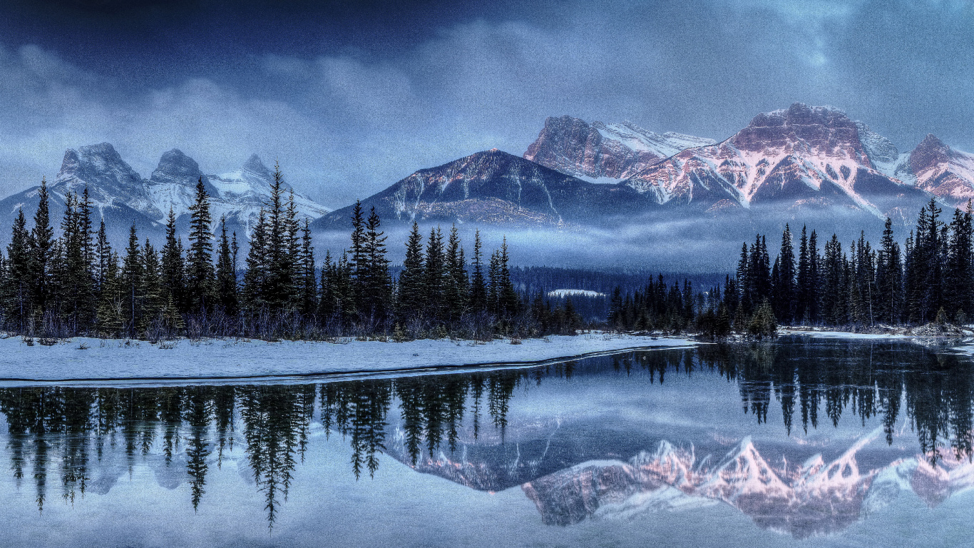 Green Pine Trees Near Snow Covered Mountain During Daytime. Wallpaper in 1366x768 Resolution