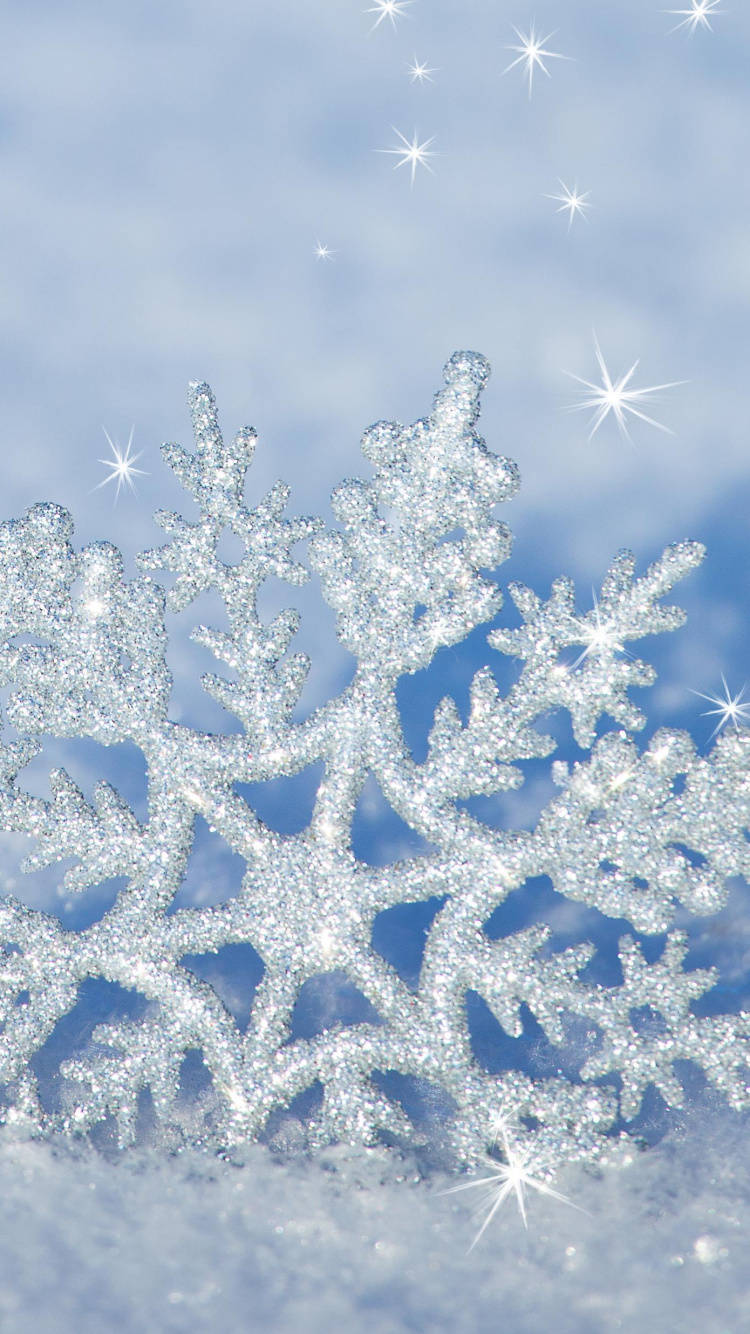 Copos de Nieve Blancos y Azules Sobre Arena Gris. Wallpaper in 750x1334 Resolution