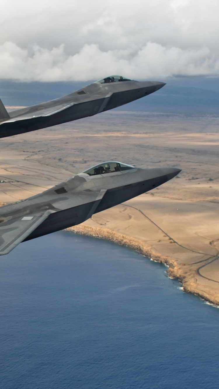 Gray Fighter Plane Flying Over The Sea During Daytime. Wallpaper in 750x1334 Resolution