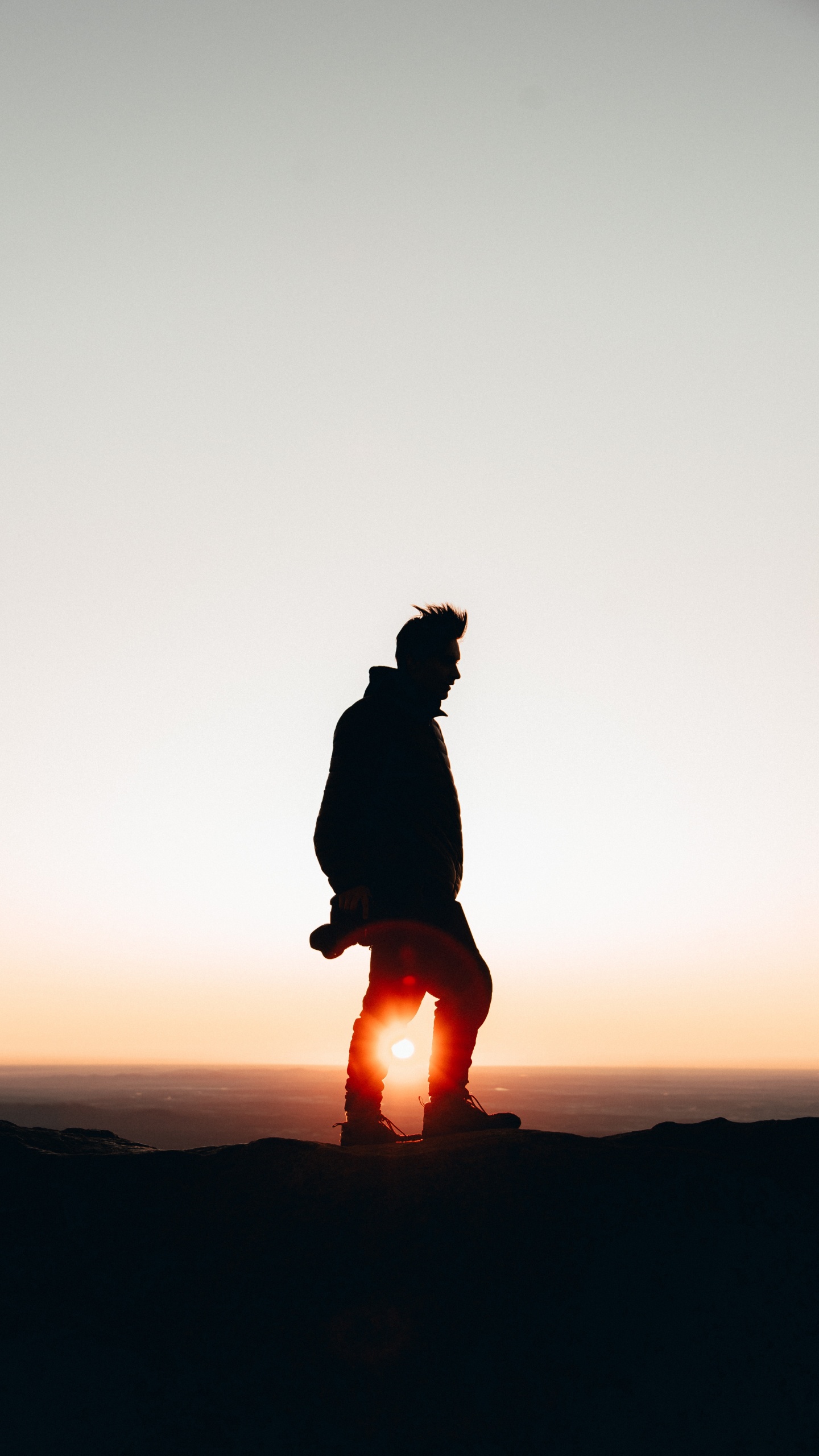 Silhouette of Person Sitting on Rock During Sunset. Wallpaper in 1440x2560 Resolution