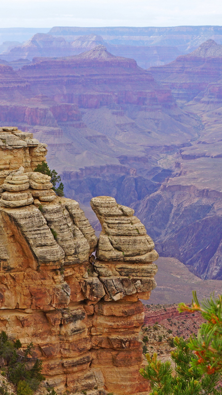 Brown Rocky Mountain Under White Sky During Daytime. Wallpaper in 750x1334 Resolution
