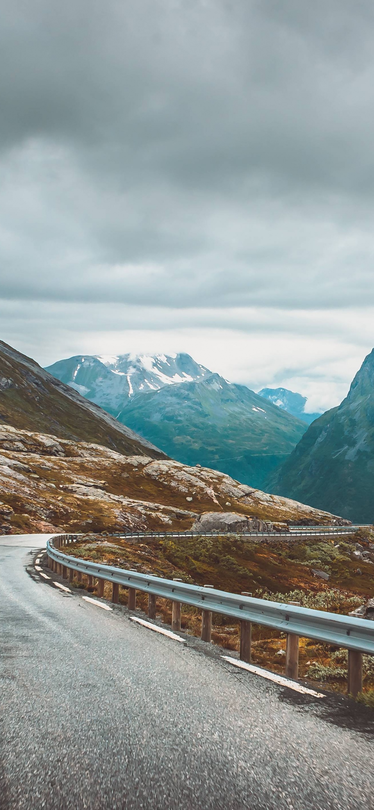 Gray Concrete Road Near Mountains During Daytime. Wallpaper in 1242x2688 Resolution