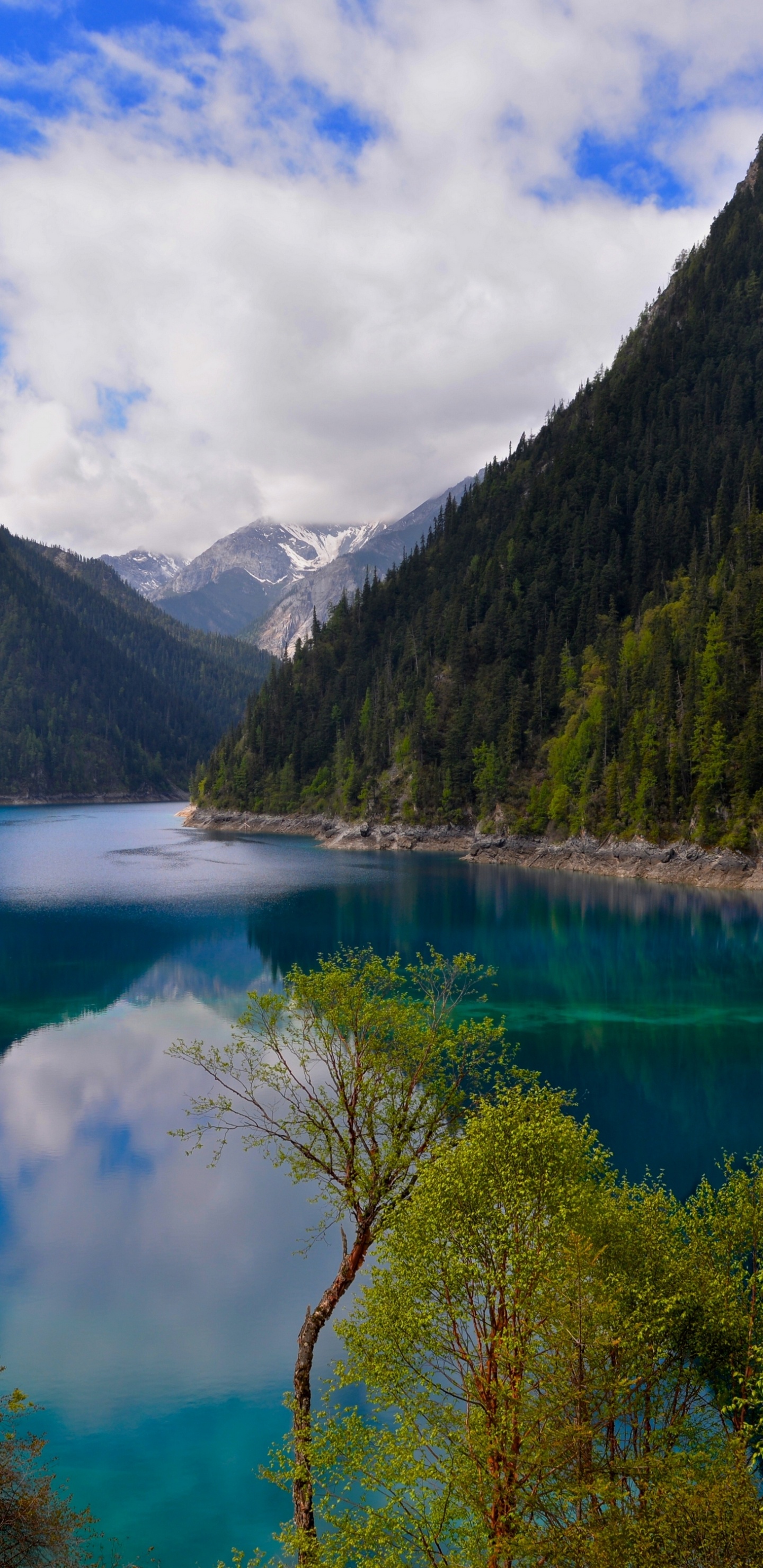 Green Mountains Beside Lake Under Blue Sky and White Clouds During Daytime. Wallpaper in 1440x2960 Resolution