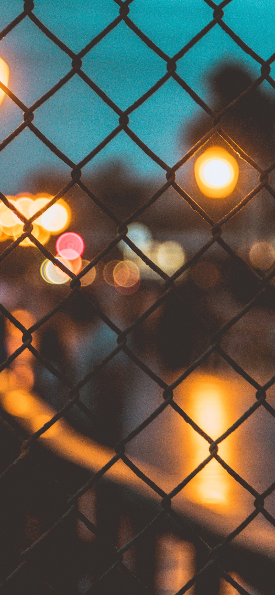 Black Metal Fence With Lights. Wallpaper in 1125x2436 Resolution