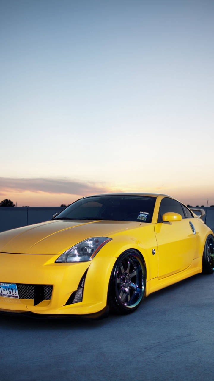 Yellow Porsche 911 on Gray Concrete Floor During Daytime. Wallpaper in 720x1280 Resolution