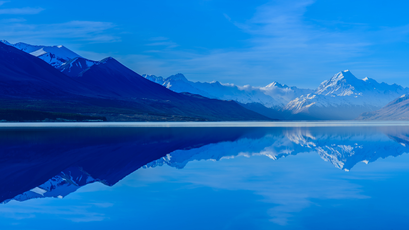 Body of Water Near Mountain Under Blue Sky During Daytime. Wallpaper in 1366x768 Resolution