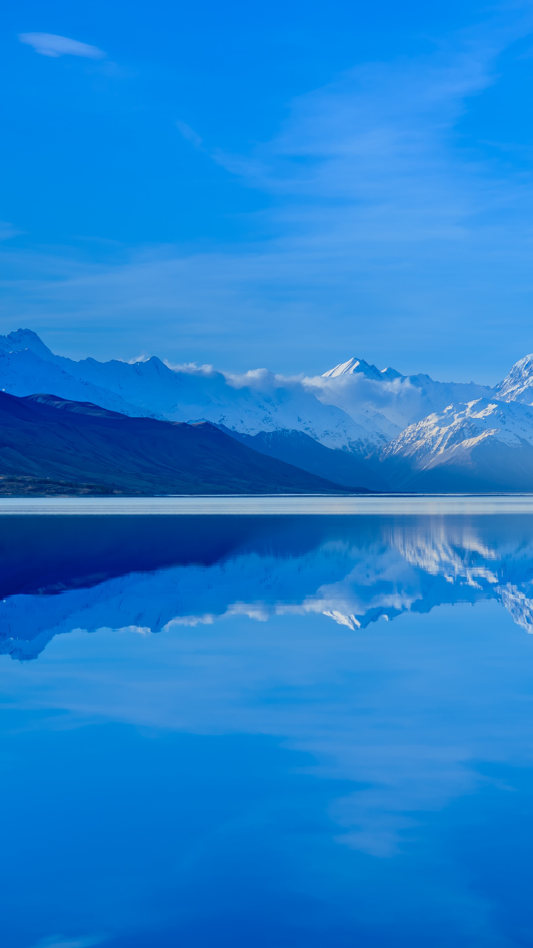 Body of Water Near Mountain Under Blue Sky During Daytime. Wallpaper in 750x1334 Resolution