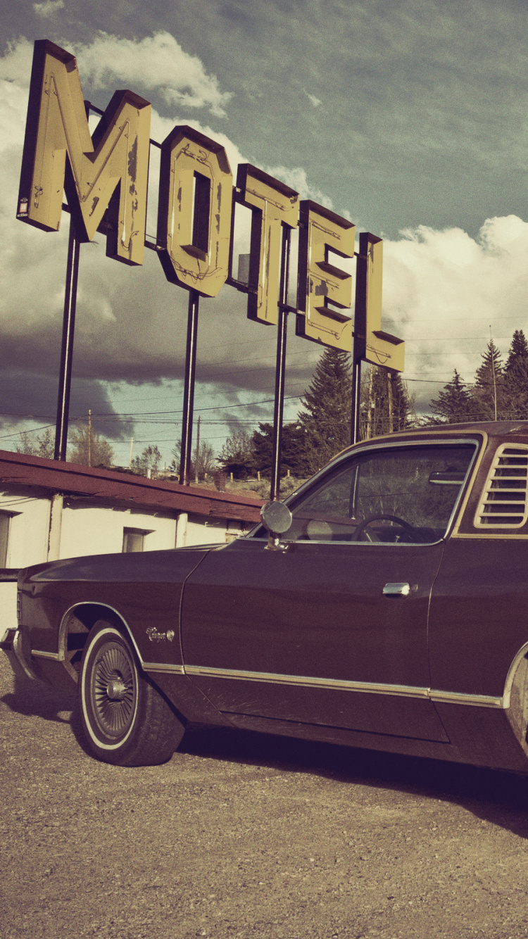 Red Sedan Parked on Gray Concrete Road Under Gray Clouds. Wallpaper in 750x1334 Resolution