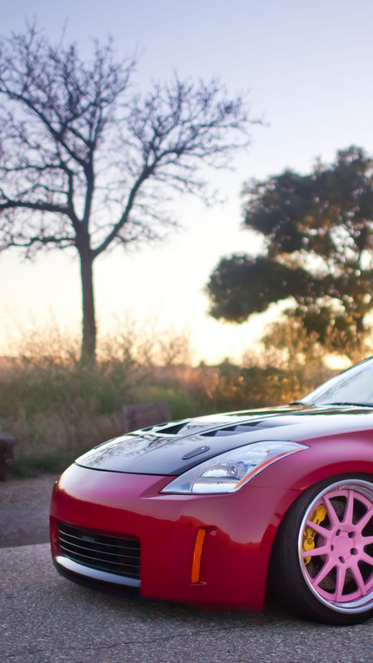 Roter Ferrari 458 Italia Tagsüber Unterwegs. Wallpaper in 750x1334 Resolution