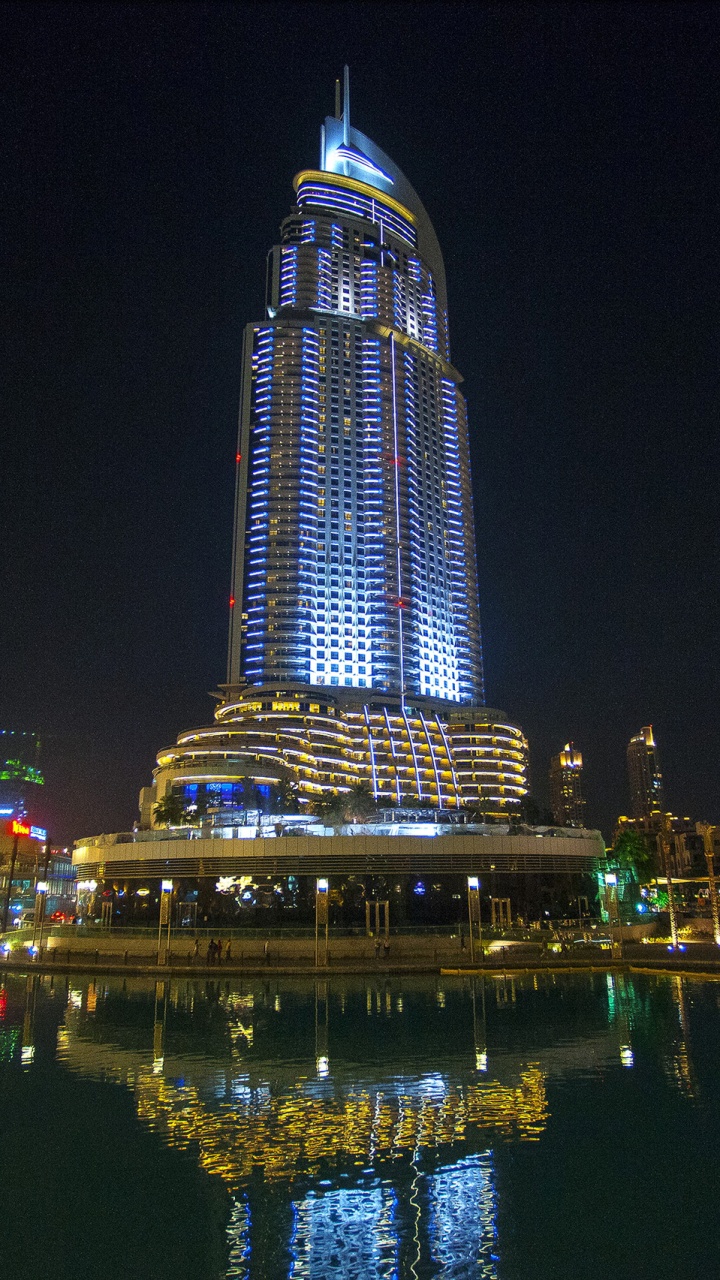 White and Black Concrete Building Near Body of Water During Night Time. Wallpaper in 720x1280 Resolution