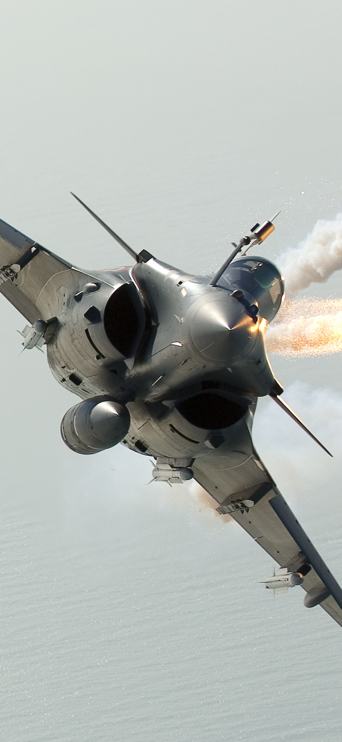 Graues Düsenflugzeug in Der Luft. Wallpaper in 1125x2436 Resolution