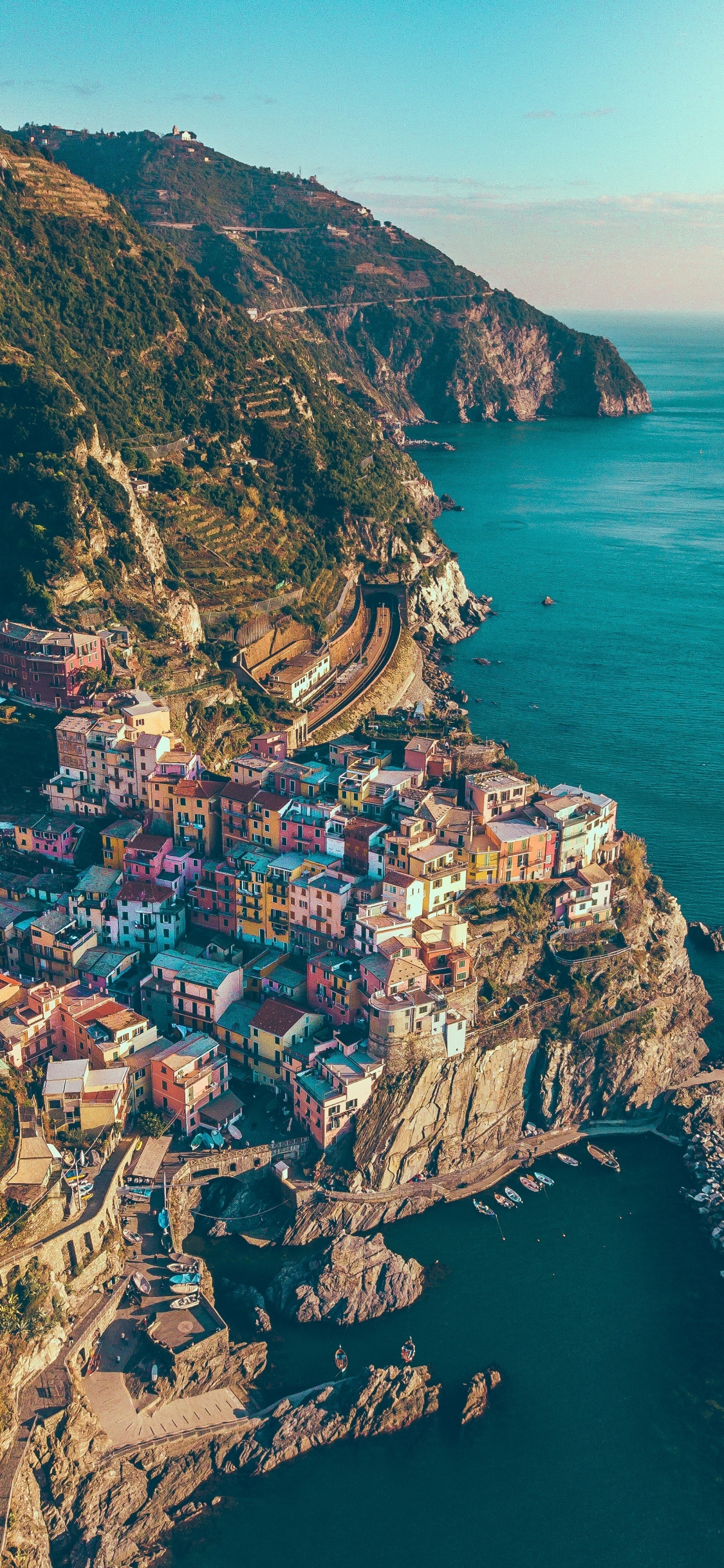 Aerial View of City Near Body of Water During Daytime. Wallpaper in 1125x2436 Resolution