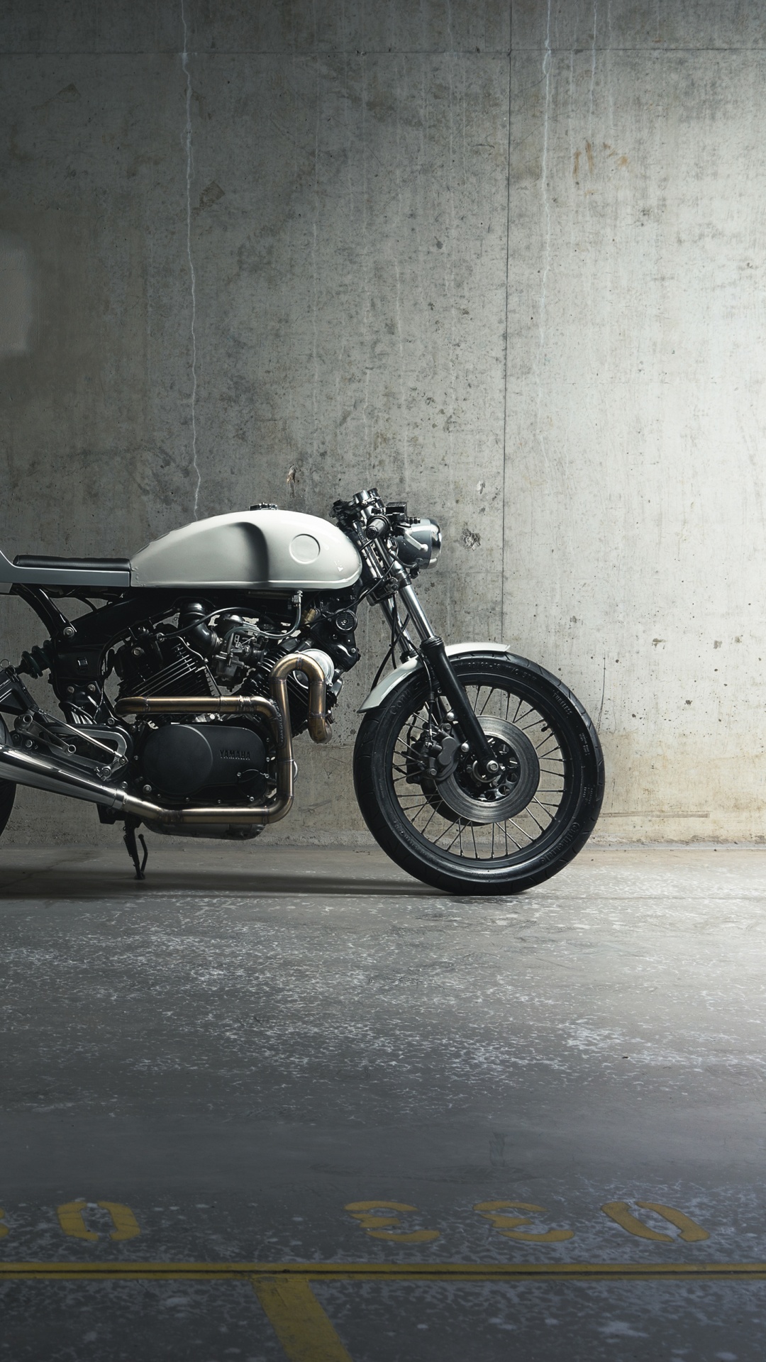 Black and Silver Motorcycle Parked Beside Gray Wall. Wallpaper in 1080x1920 Resolution