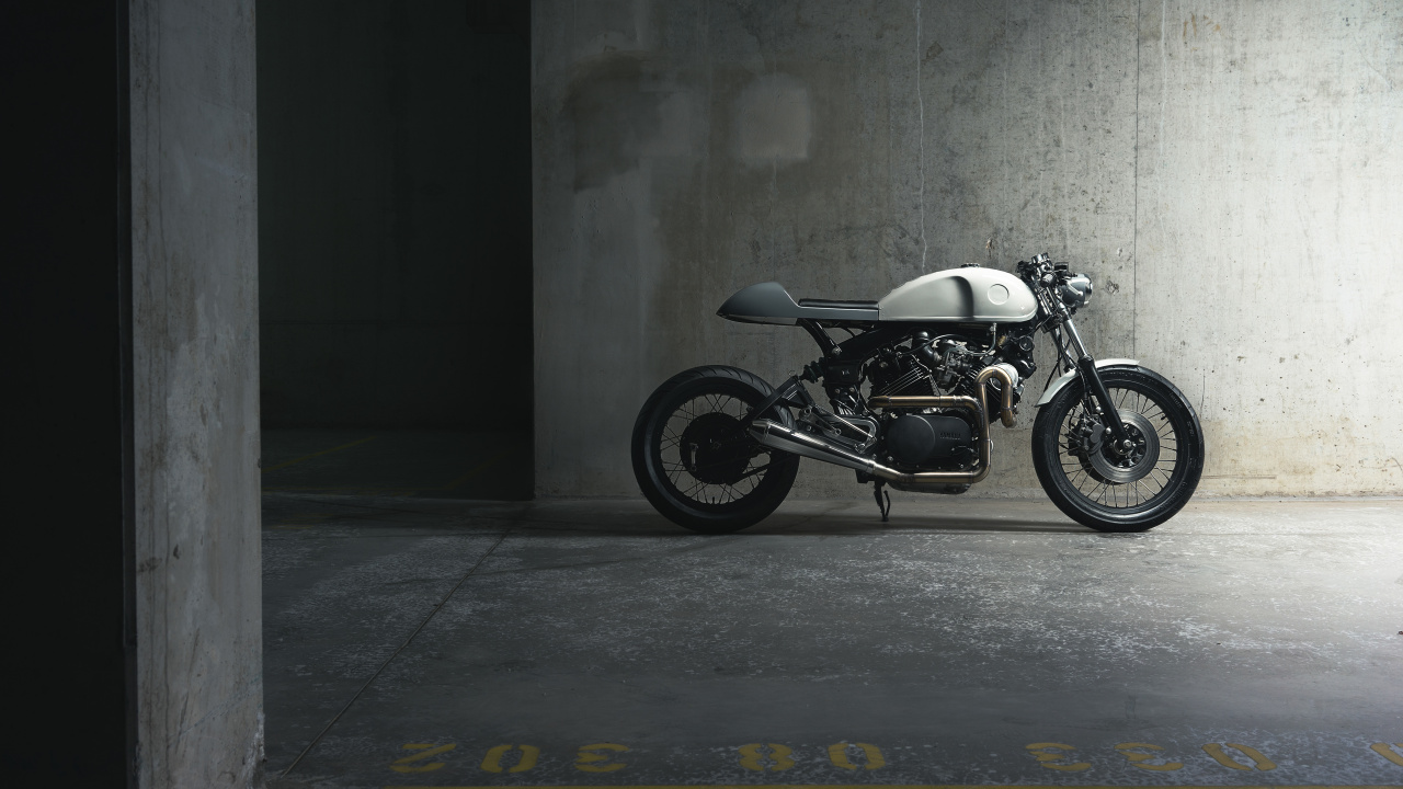 Black and Silver Motorcycle Parked Beside Gray Wall. Wallpaper in 1280x720 Resolution