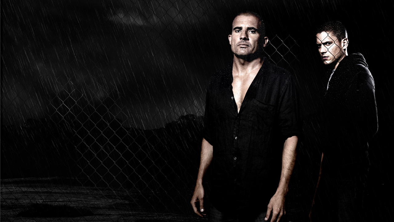 Man in Black Button up Shirt Standing Beside Gray Metal Fence. Wallpaper in 1280x720 Resolution