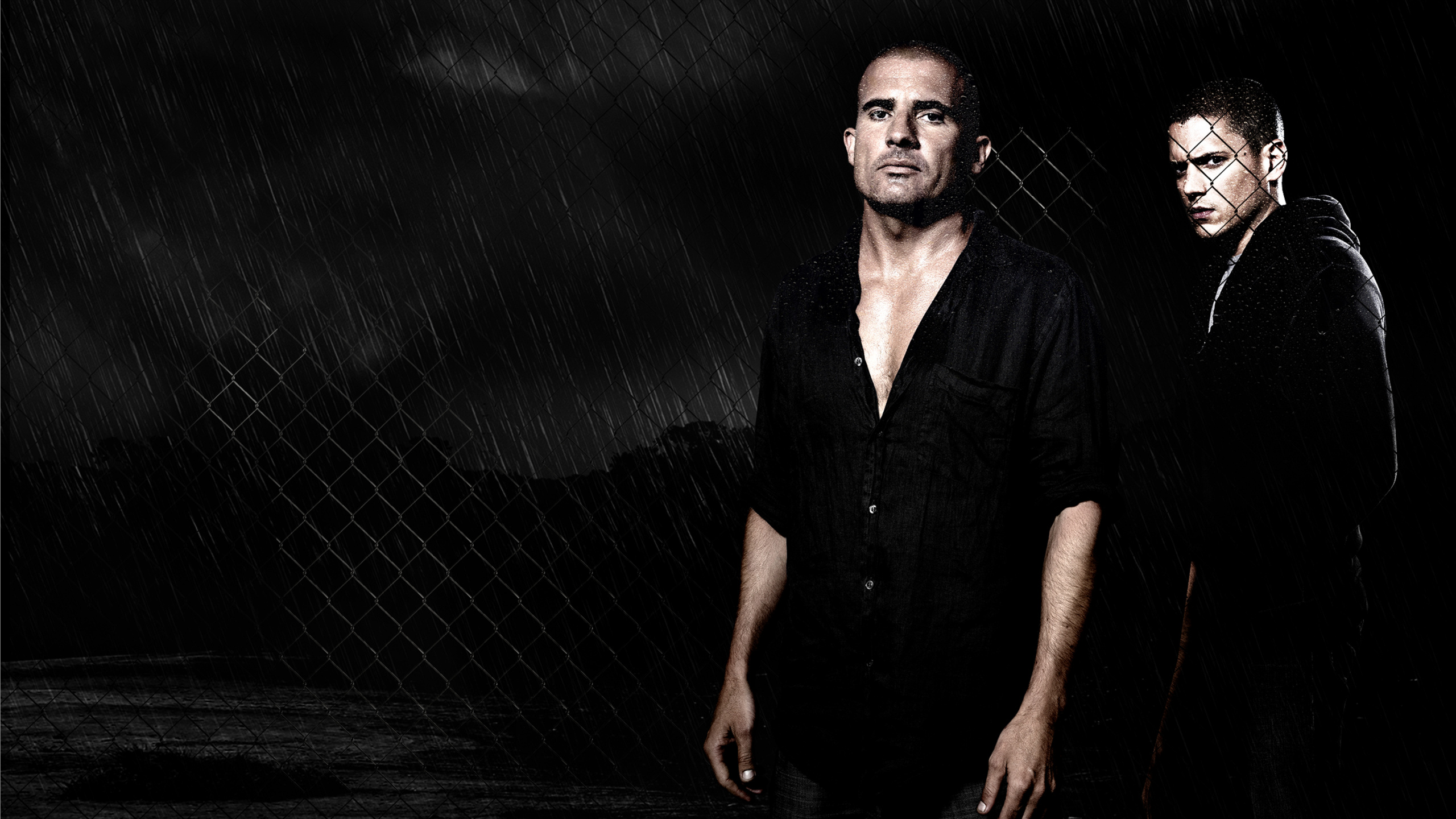 Man in Black Button up Shirt Standing Beside Gray Metal Fence. Wallpaper in 2560x1440 Resolution