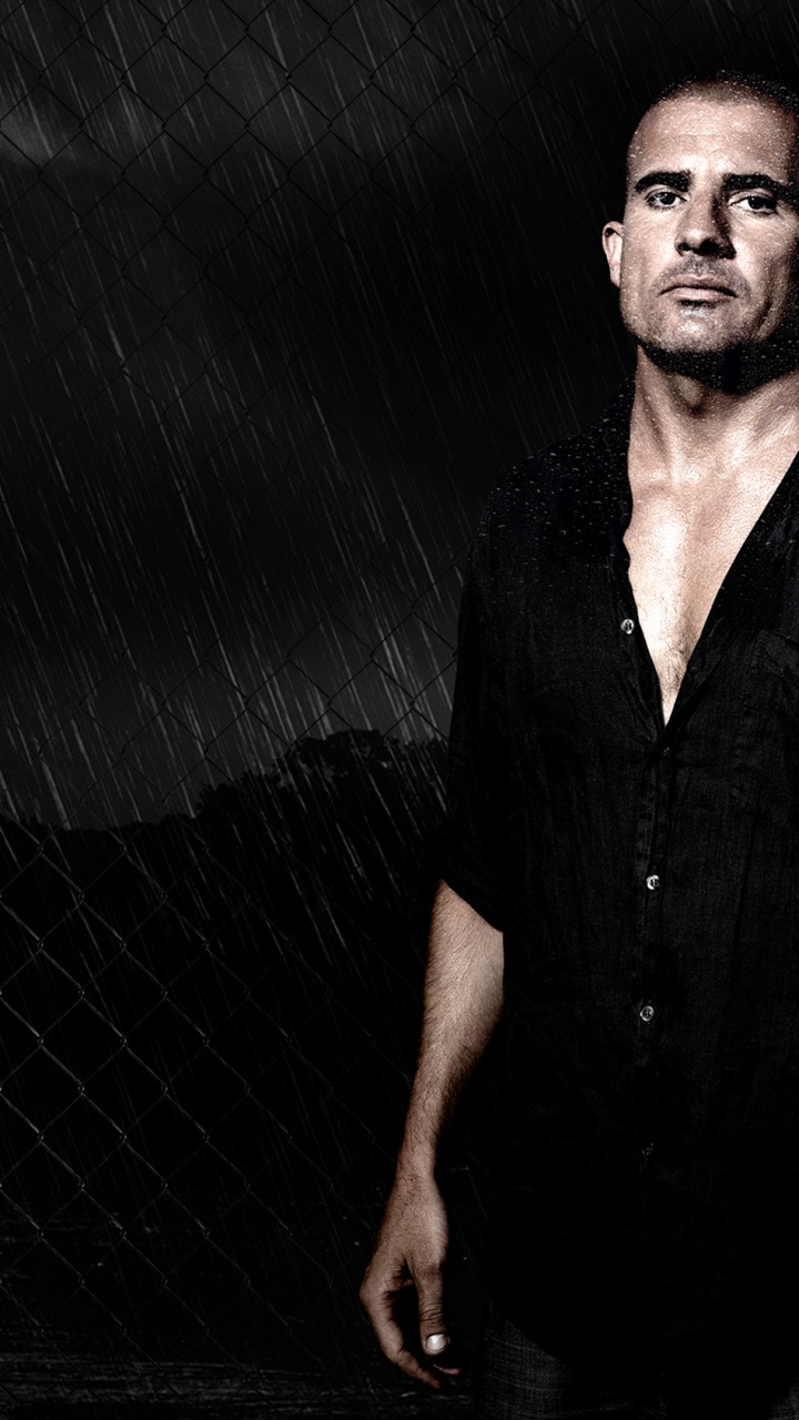 Man in Black Button up Shirt Standing Beside Gray Metal Fence. Wallpaper in 720x1280 Resolution