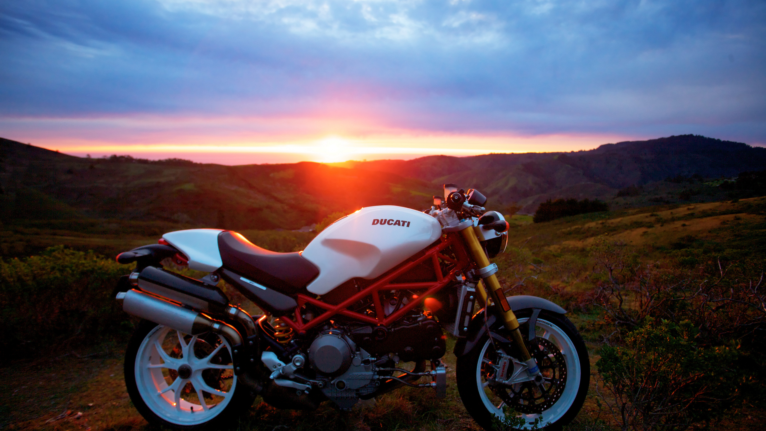 White and Black Cruiser Motorcycle on Green Grass Field During Sunset. Wallpaper in 2560x1440 Resolution