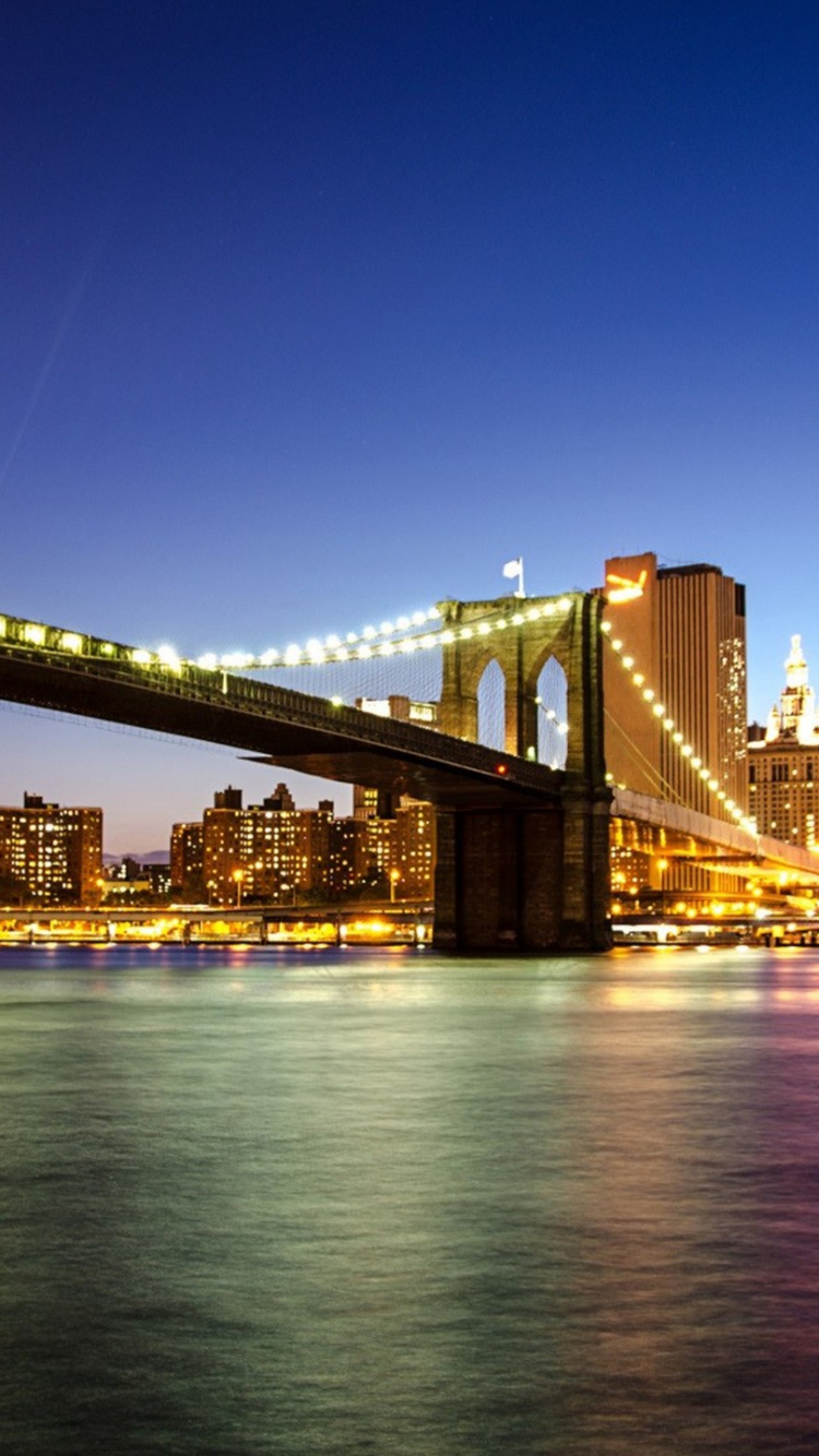 Bridge Over Water During Night Time. Wallpaper in 750x1334 Resolution